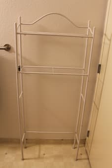 Shelves over toilet, swing-top trash can, and closet hanging shelves 1
