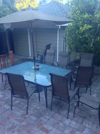 Large outdoor table with comfy chairs and huge umbrella $400 1