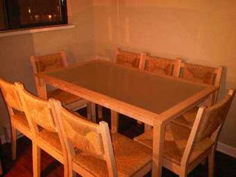 Blond hardwood, glass inset dining table with 8 chairs $300 1