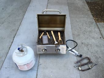 NVR Tabletop Propane Grill With Propane Tank, Grilling Tools, and Cooler 1