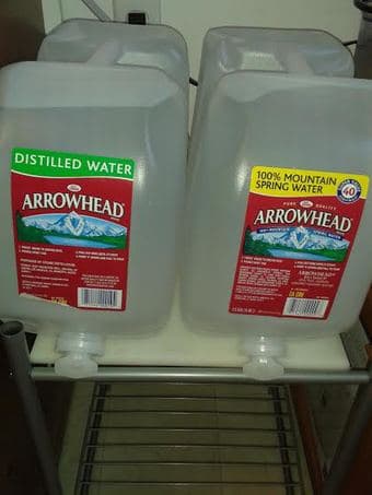 Distilled / spring water cans of 2.5 gallon each 1