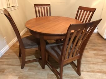 Wooden round dining table with 4 cushioned chairs 1