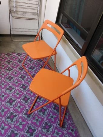 Bright orange folding chairs and pink patio rug for sale! 1
