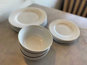 Full set of clean, white dishes (plates, bowls) 1