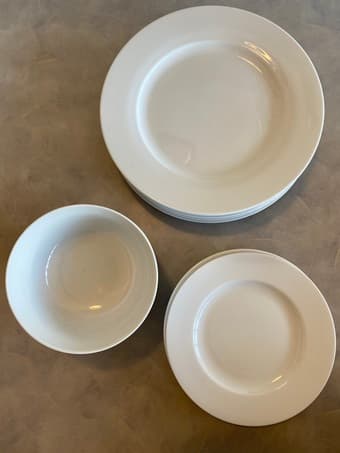 Full set of clean, white dishes (plates, bowls) 3