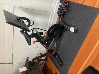 Lightly Used Peloton Bike with 3 lb weights and mat 2