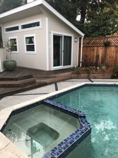 Adorable separate pool house behind large modern house 1