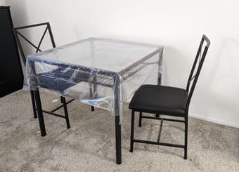 Glass-top dining table with two chairs 1