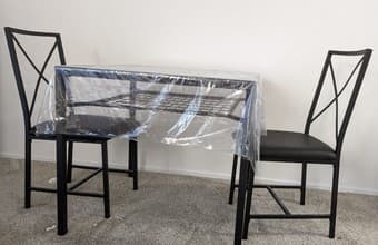 Glass-top dining table with two chairs 2